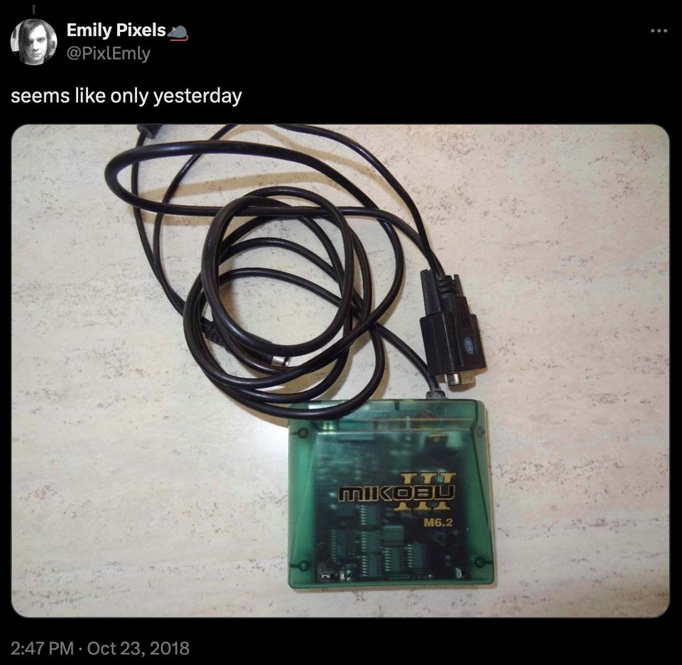 Mikobu III M6.2 with a green translucent case and a black 9-pin serial cable, in a tweet from Emily Pixels @PixlEmly